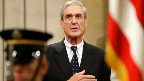 Reuters Outgoing FBI Director Robert Mueller stands for the national anthem during a farewell ceremony for him at the Justice Department in Washington, August 1, 2013.