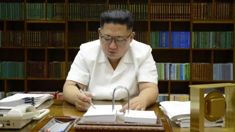 KCNA July 27, 2017 picture released from North Korea"s official Korean Central News Agency (KCNA) on July 29, 2017 shows North Korean leader Kim Jong-Un signing documents for test launch of an intercontinental ballistic missile (ICBM)