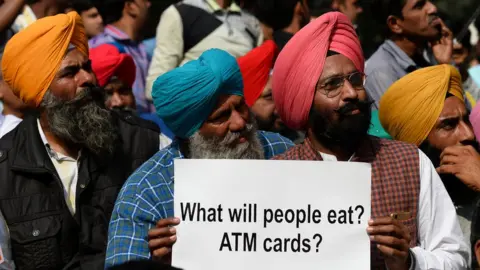 Getty Images An man holding a placard during a protest against demonetisation in New Delhi on November 23, 2016.