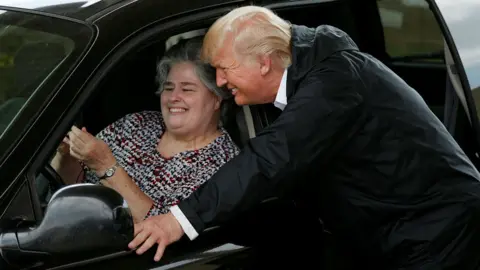Reuters President Donald Trump poses for a selfie during a visit to meet flood survivors and volunteers in Houston, Texas, U.S., September 2, 2017