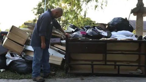 Getty Images Ernesto Ramirez pauses as he cleans out his house that had been inundated with water on September 2, 2017 in Houston, Texas.