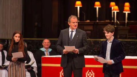 PA Hugh Bonneville (centre) with Madeleine Harris and Samuel Joslin