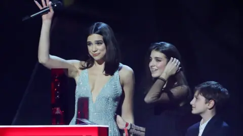 Reuters Dua Lipa with her younger sister and brother